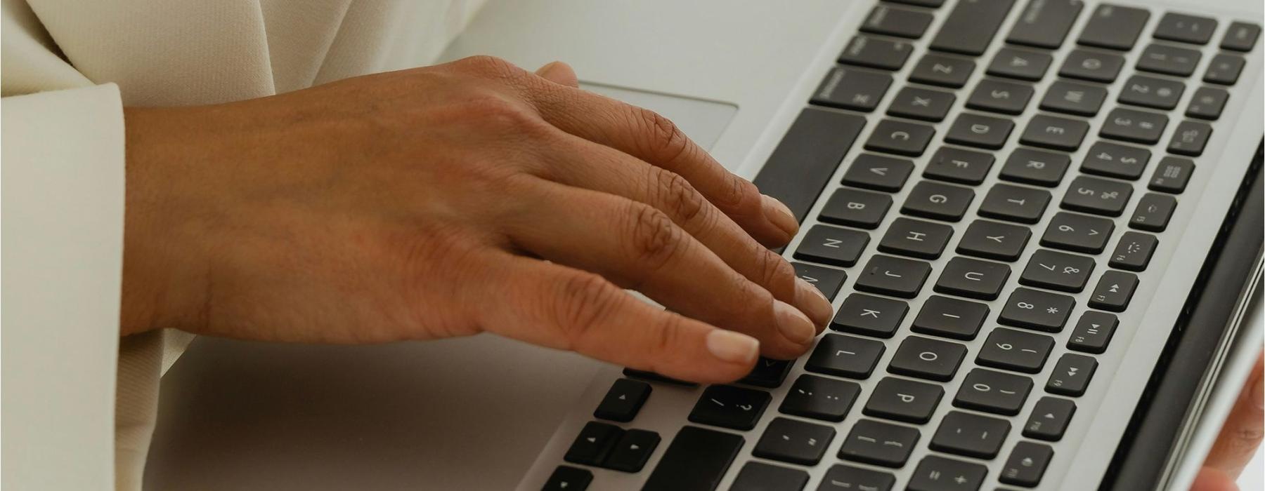 a person typing on a laptop