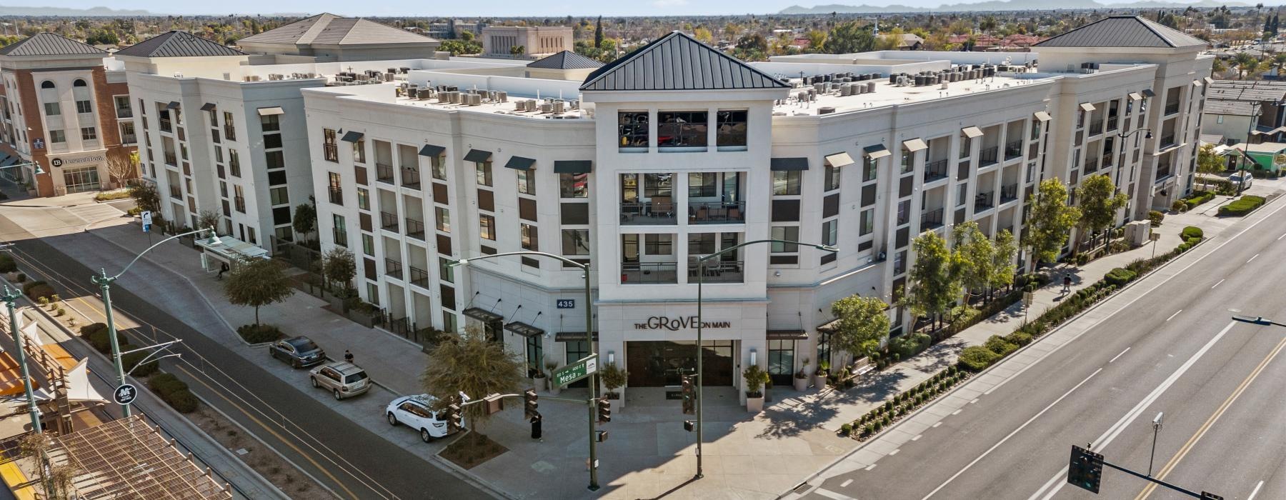 a large white building with a parking lot in front of it