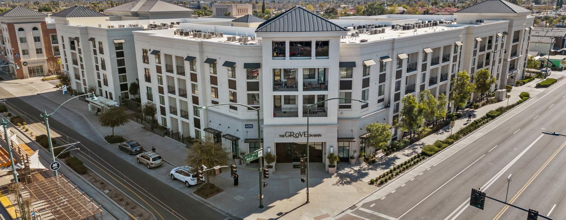 a large white building with a parking lot in front of it